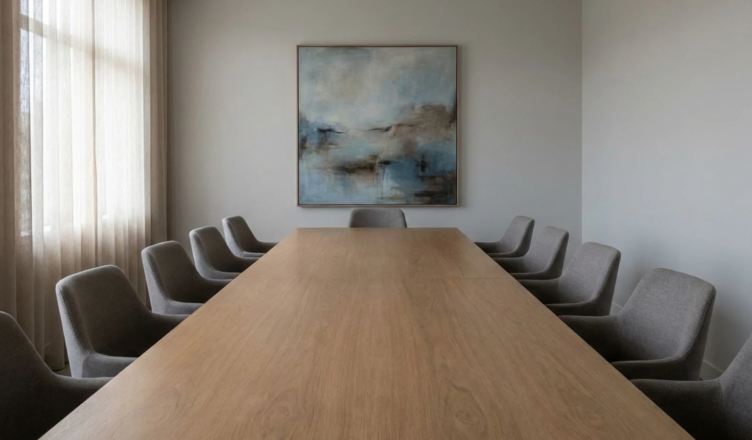 Boardroom table with empty chairs representing consensus and decision-making risk